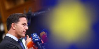 Cheltuielile NATO în Europa au crescut cu 20% în 2025: Rutte cere drum clar spre ținta de 5% Mark Rutte, secretarul general NATO, vorbeste la microfoane in cadrul unui summit european. Profil din stanga, costum inchis, cravata verde. Microfoane WDR si alte posturi media vizibile. Fundal albas